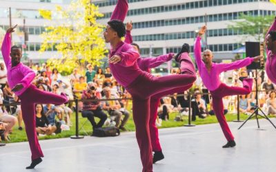 a group of male African American modern dancers performing outdoors