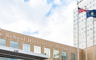 photograph of the Philadelphia School District building with the American flag, and the Philadelphia state flag outside