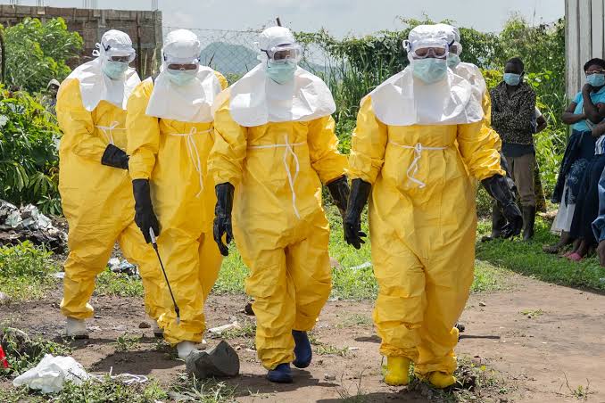 health professionals in protective suits and equipment  