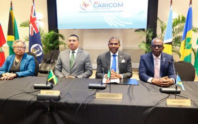The image shows Caribbean Community (CARICOM) leaders and officials—including CARICOM Secretary-General Dr. Carla Barnett, Jamaica's Prime Minister Andrew Holness, St. Kitts and Nevis Prime Minister Terrance Drew, and Saint Lucia Prime Minister Philip J. Pierre—at the 50th Regular Meeting of the Conference of CARICOM Heads of Government.